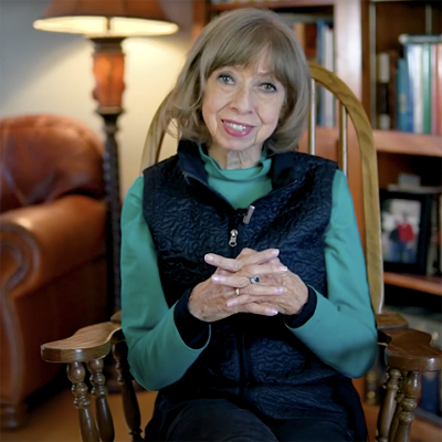 Janis Allen hosting a video from her living room